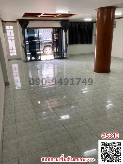 Spacious interior of a building with shiny tiled flooring and pillar