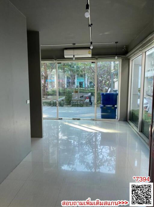 Empty commercial space interior with large storefront windows