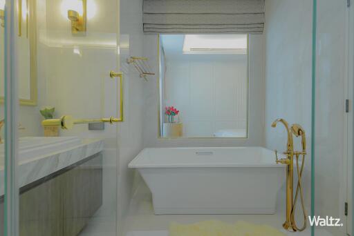 Modern bathroom with gold fixtures and marble countertop