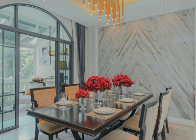 Elegant dining room with modern chandelier and large windows