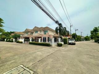 Spacious two-story house with a large front yard and gated entrance