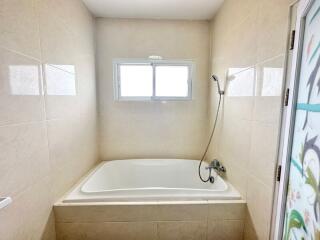 Spacious Bathroom with a Large Bathtub and Shower