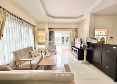 Bright and spacious living room with modern furniture and kitchenette