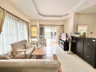 Bright and spacious living room with modern furniture and kitchenette