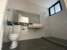 Modern bathroom with neutral colors and wall-mounted sink