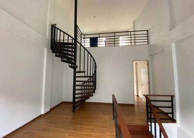 Spacious interior with a spiral staircase and high ceilings