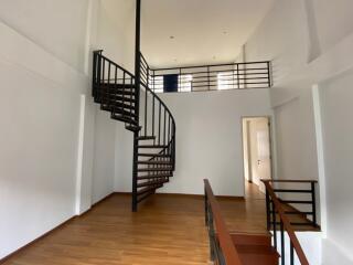 Spacious interior with a spiral staircase and high ceilings