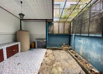 Private enclosed patio with partial cover and storage space