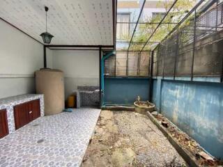 Private enclosed patio with partial cover and storage space