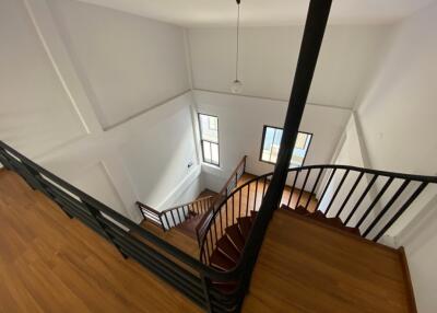 Elegant staircase with wooden steps and wrought-iron railing in a modern home