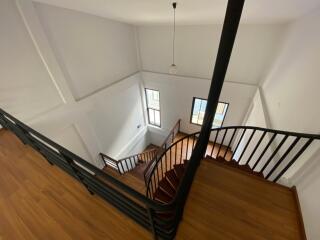 Elegant staircase with wooden steps and wrought-iron railing in a modern home