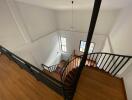 Elegant staircase with wooden steps and wrought-iron railing in a modern home