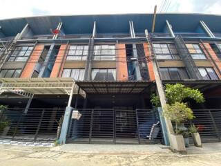 Contemporary multi-story building facade with balconies and garage