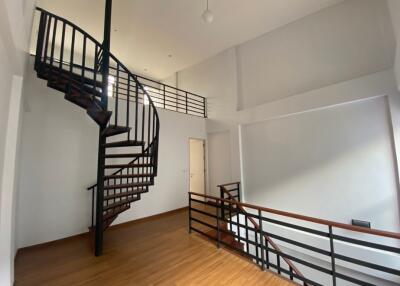Spacious Interior with High Ceilings and Spiral Staircase