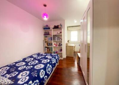 Cozy bedroom with hardwood floors and ample storage space