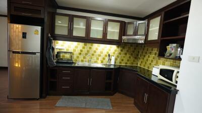 Spacious kitchen with modern appliances and wooden cabinetry