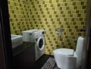 Small bathroom with yellow tile walls, modern fixtures, and washing machine