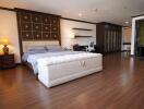 Spacious master bedroom with elegant design and hardwood flooring