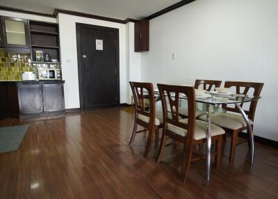 Spacious combined kitchen and dining room with modern amenities and wooden flooring