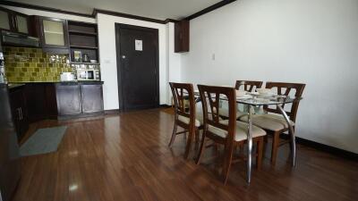 Spacious combined kitchen and dining room with modern amenities and wooden flooring