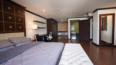 Spacious and elegantly furnished master bedroom with work area