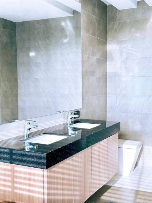 Modern bathroom interior with marble tiles and double sink