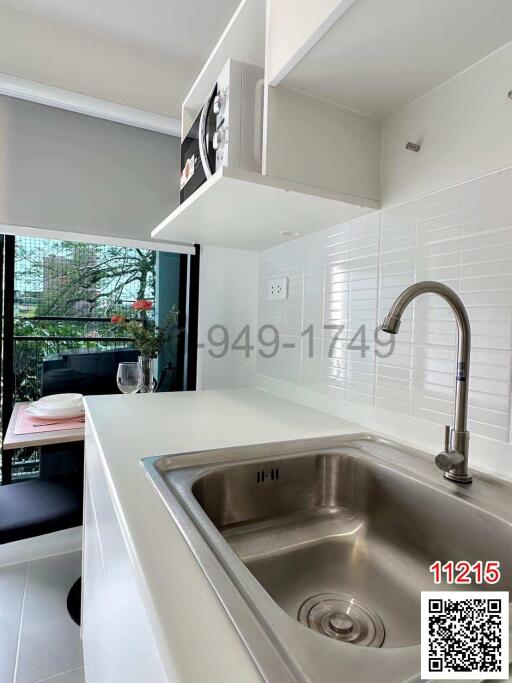 Modern kitchen with stainless steel sink and white countertops