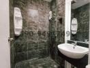 Modern tiled bathroom with a glass shower enclosure and sink