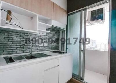 Modern kitchen with white cabinetry and brick backsplash