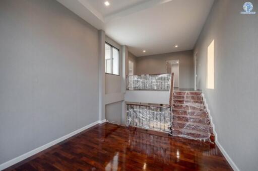 Polished hardwood stairway with protective covering in a modern home