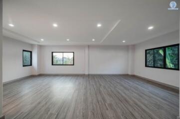 Spacious bedroom with modern lighting and large windows