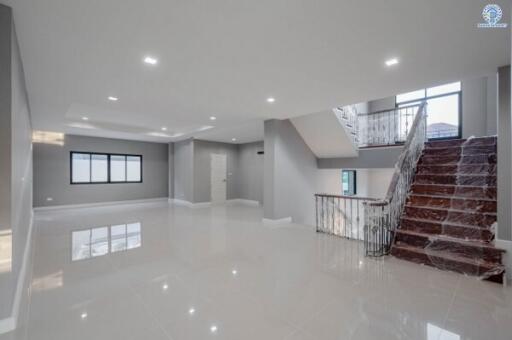 Spacious living room with high ceiling and modern lighting