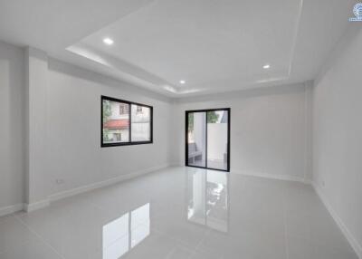Spacious and bright empty living room with glossy floor tiles and modern windows