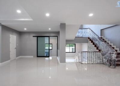 Spacious and modern living area with staircase and well-lit interior