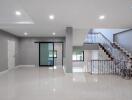 Spacious and modern living area with staircase and well-lit interior