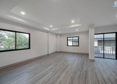 Spacious and brightly lit empty living space with modern recessed lighting and large windows