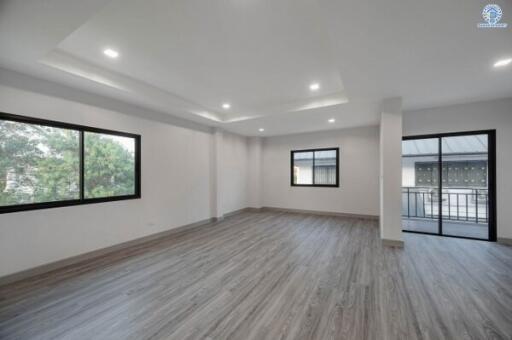 Spacious and brightly lit empty living space with modern recessed lighting and large windows