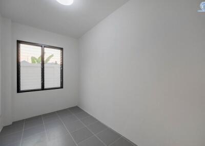 Bright and empty bedroom with tiled flooring and window
