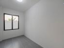 Bright and empty bedroom with tiled flooring and window