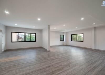 Spacious empty interior room with large windows and modern flooring