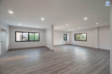Spacious empty interior room with large windows and modern flooring