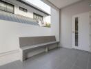 Spacious tiled patio with bench and modern exterior