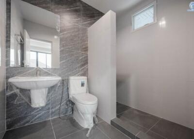 Modern bathroom interior with marble tiles and natural light