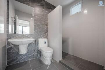 Modern bathroom interior with marble tiles and natural light