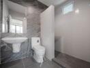 Modern bathroom interior with marble tiles and natural light