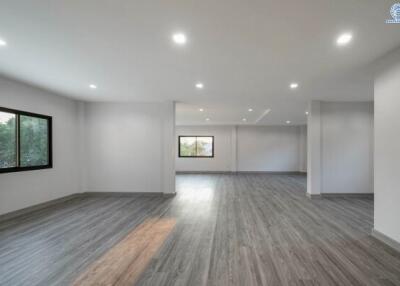 Spacious and well-lit living room with modern flooring