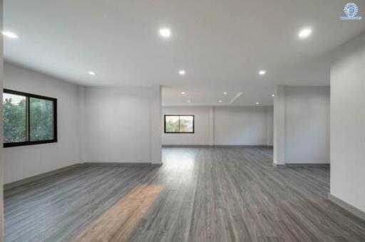 Spacious and well-lit living room with modern flooring