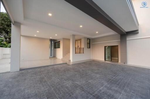 Spacious and well-lit empty carport area of a modern building