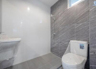 Modern bathroom with gray tiles and white facilities