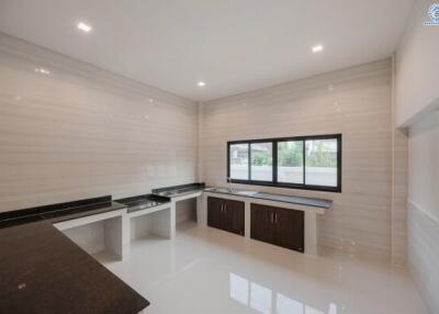 Modern spacious kitchen with large windows and marble flooring